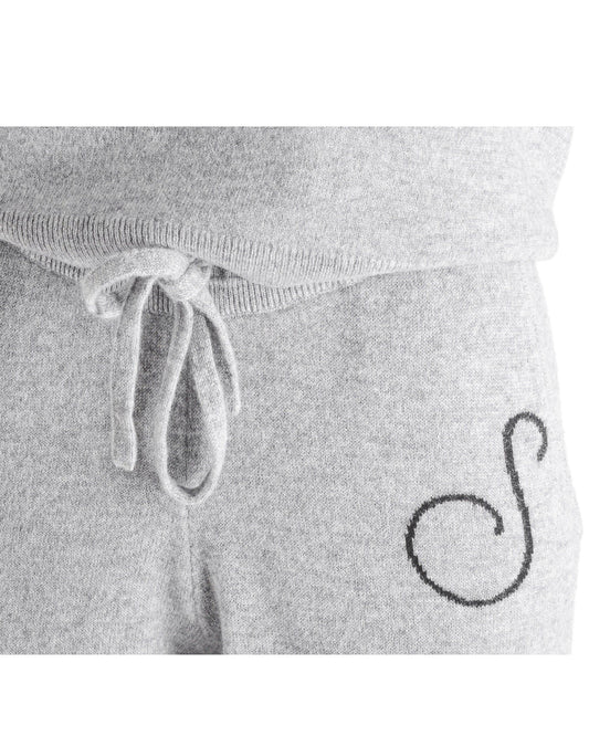 Gray sweatpants with a drawstring and a logo on a white background