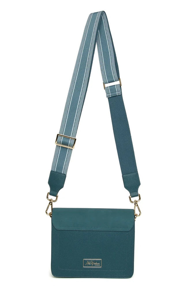 Teal crossbody bag with a strap on a white background