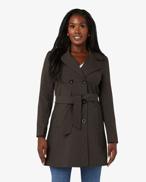 Woman wearing a brown trench coat on a white background