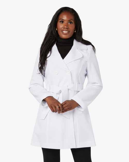 Woman wearing a white coat on a white background