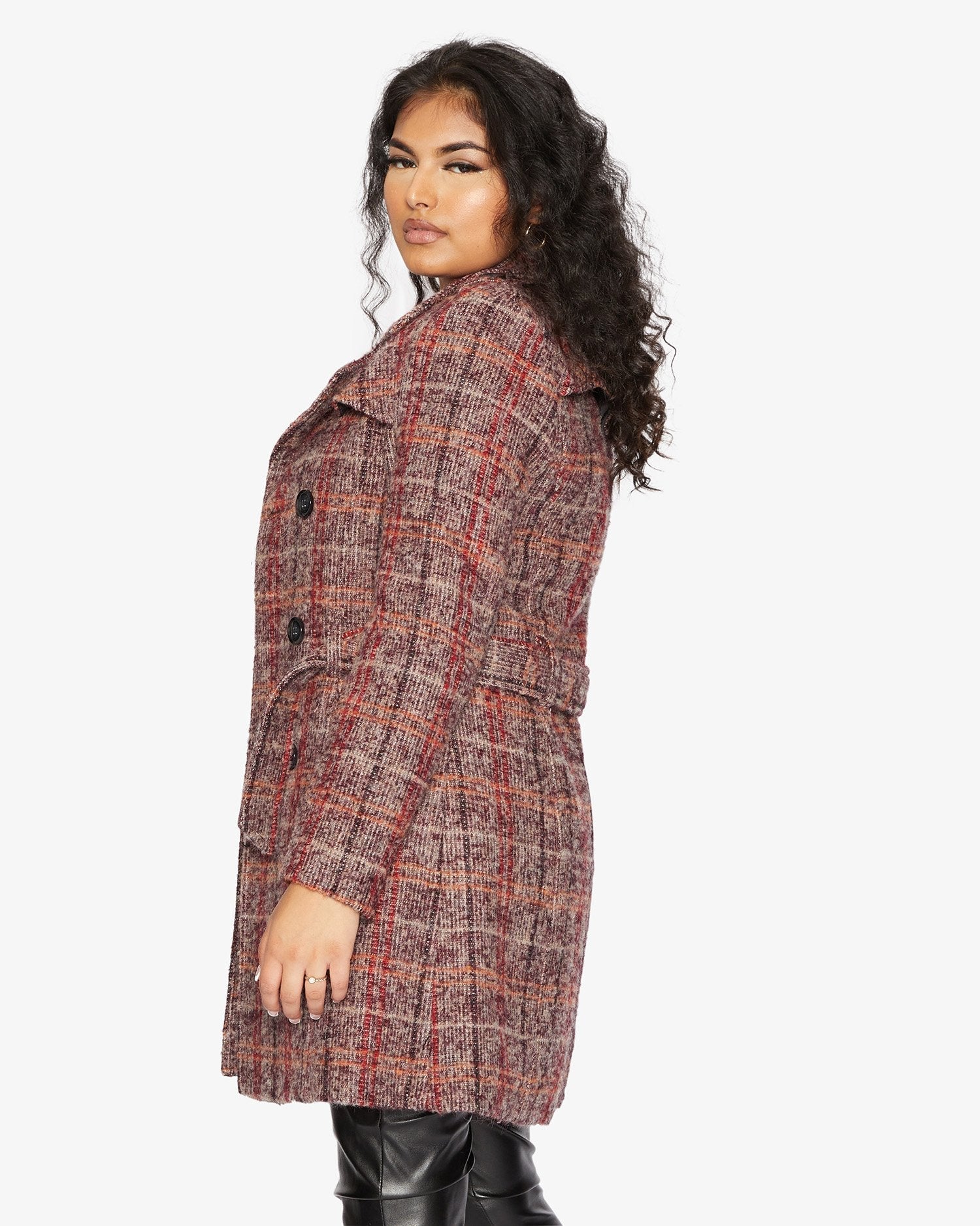 Woman wearing a plaid coat on a white background