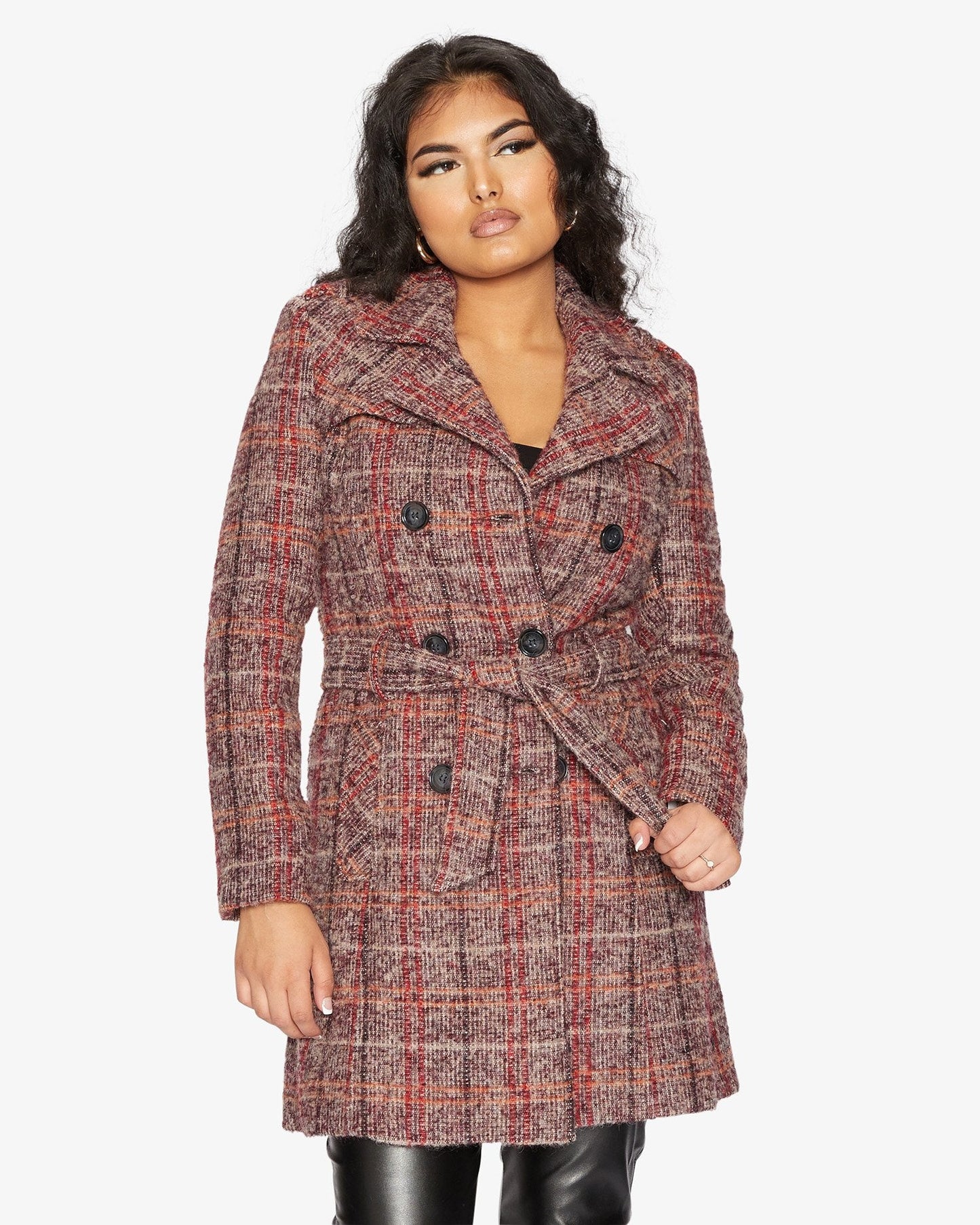 Woman wearing a plaid coat on a white background