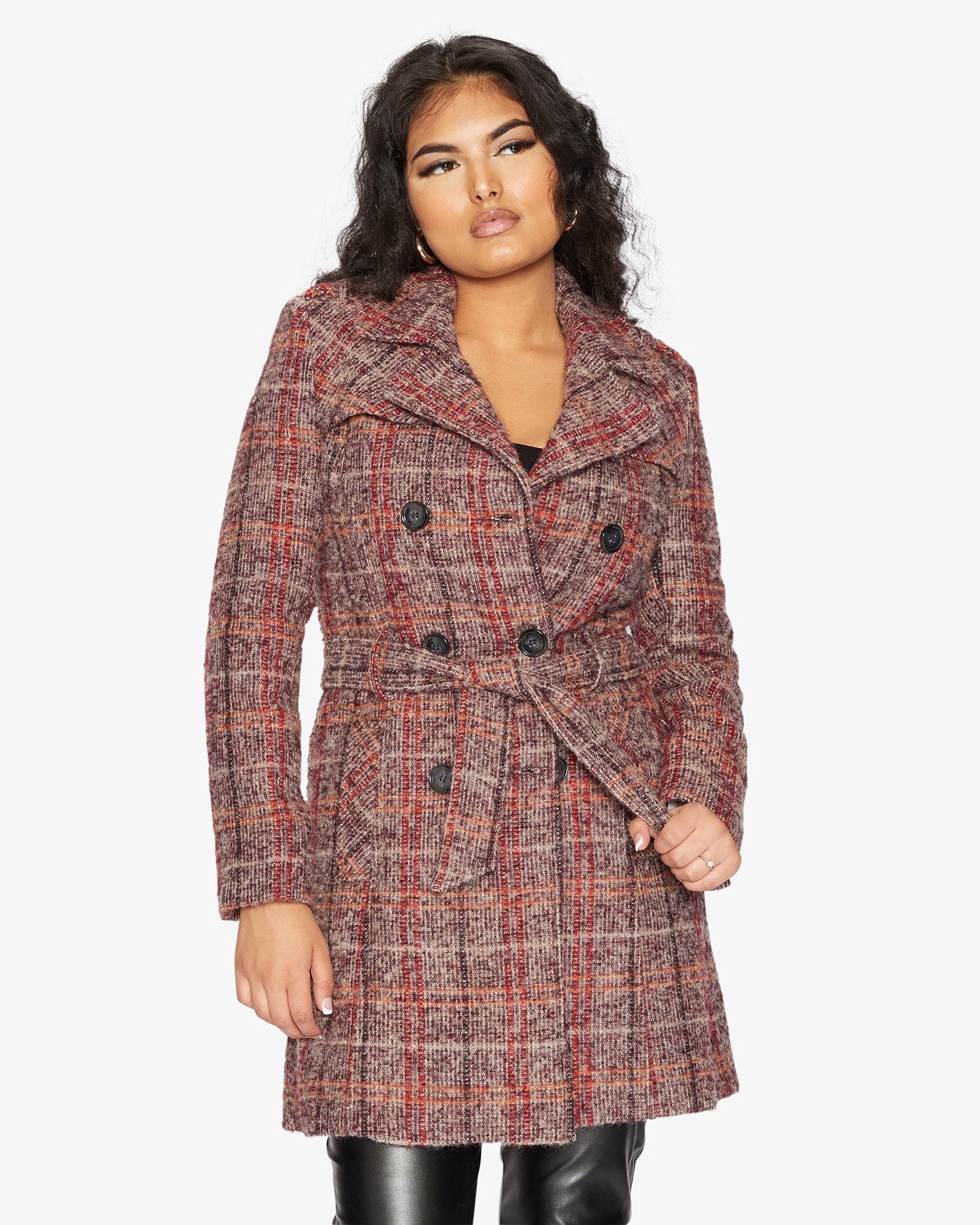 Woman wearing a plaid coat on a white background