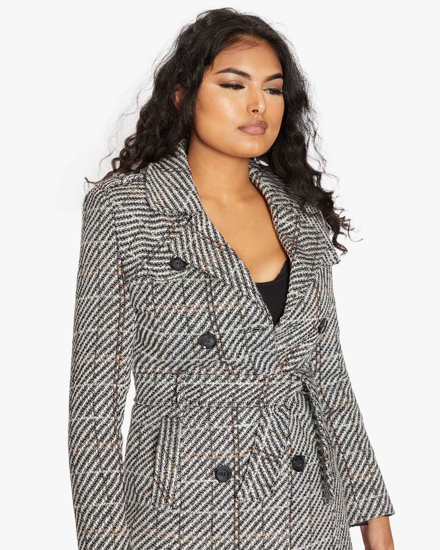 Woman wearing a patterned coat on a white background