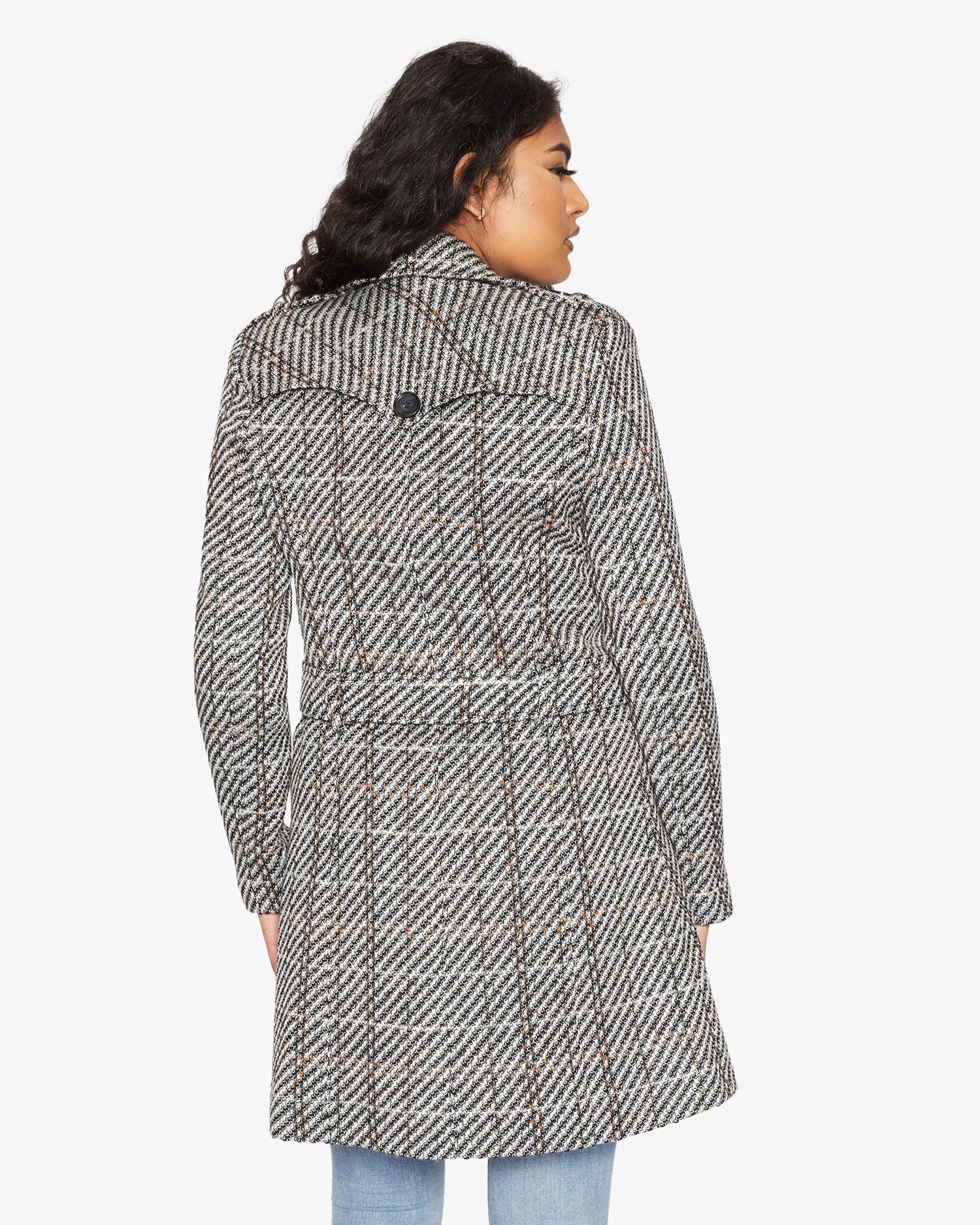 Woman wearing a patterned coat on a white background