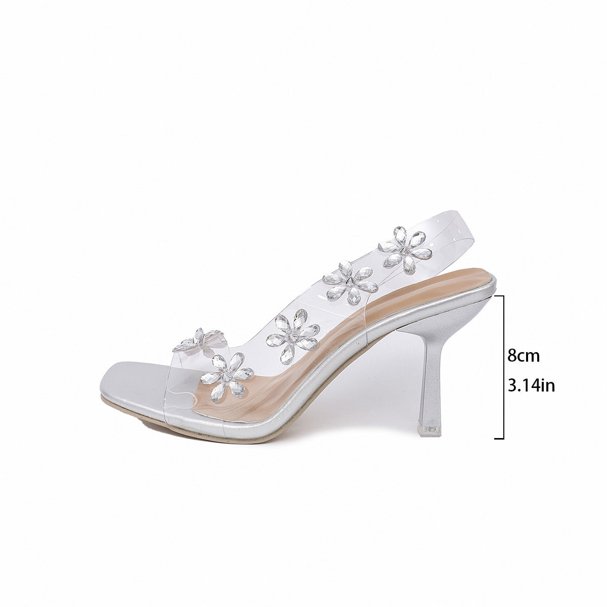 White high-heeled shoe with floral embellishments on a white background