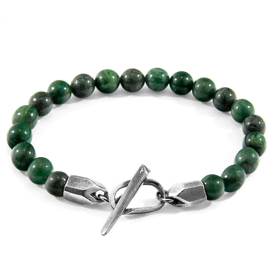 Green beaded bracelet with a silver clasp on a white background