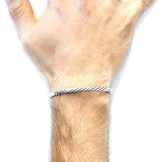 Hand wearing a silver bracelet on a white background