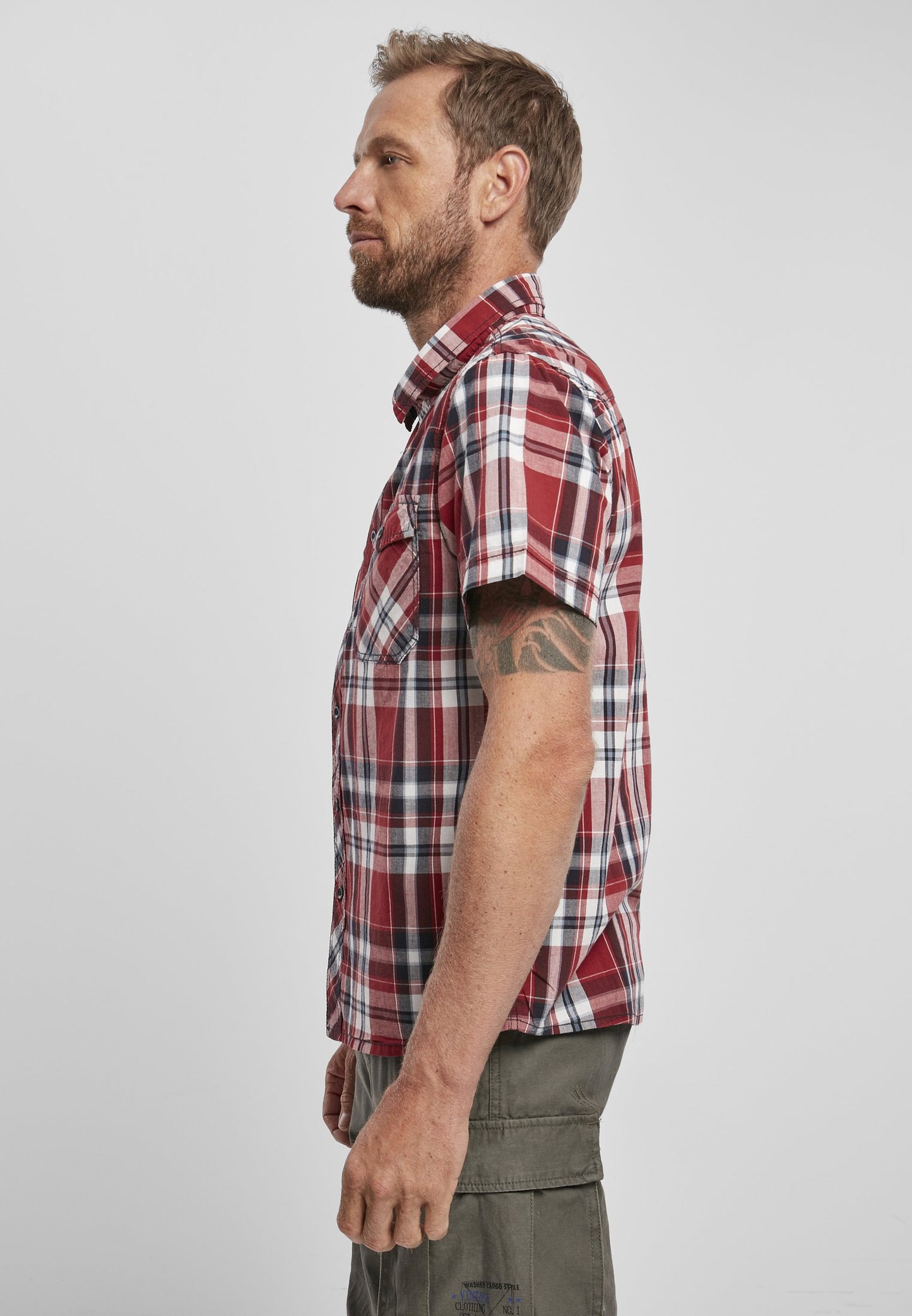 Man wearing a red plaid shirt against a white background