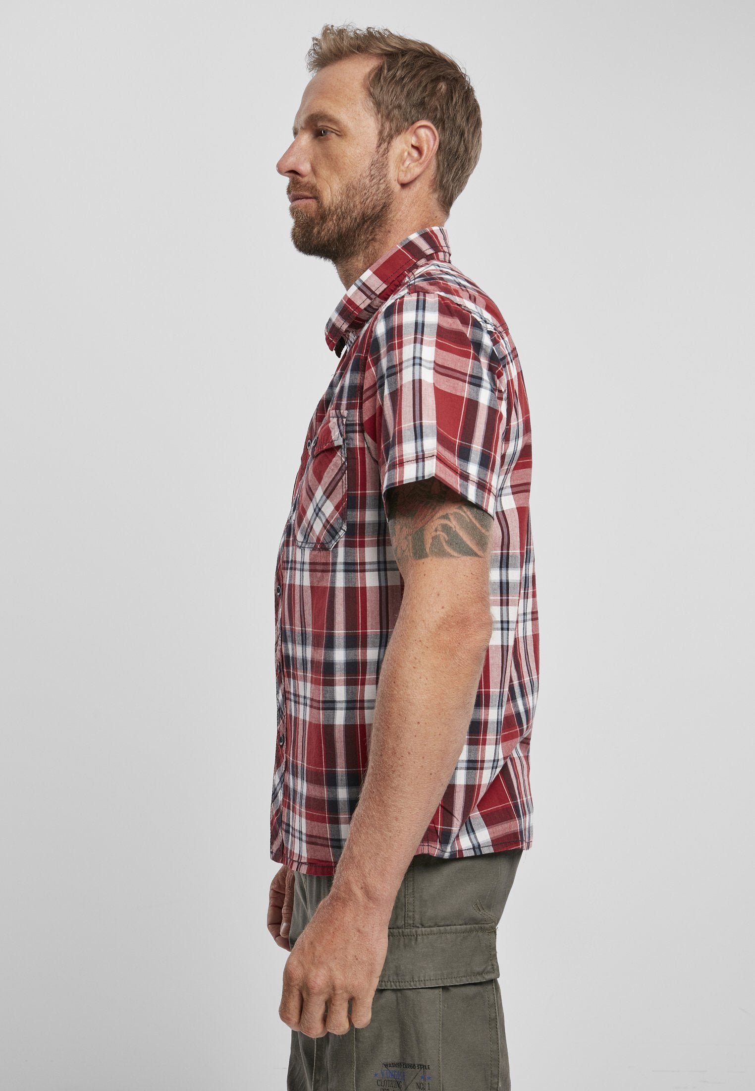 Man wearing a red plaid shirt against a white background