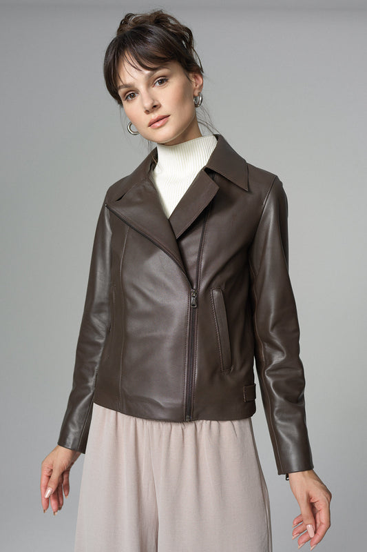 Woman wearing a brown leather jacket on a gray background