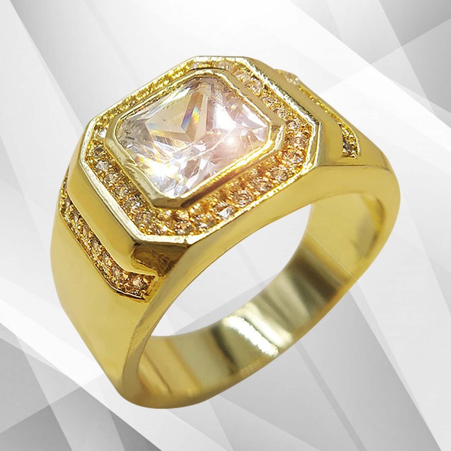 Gold ring with a large central gemstone on a light gray background