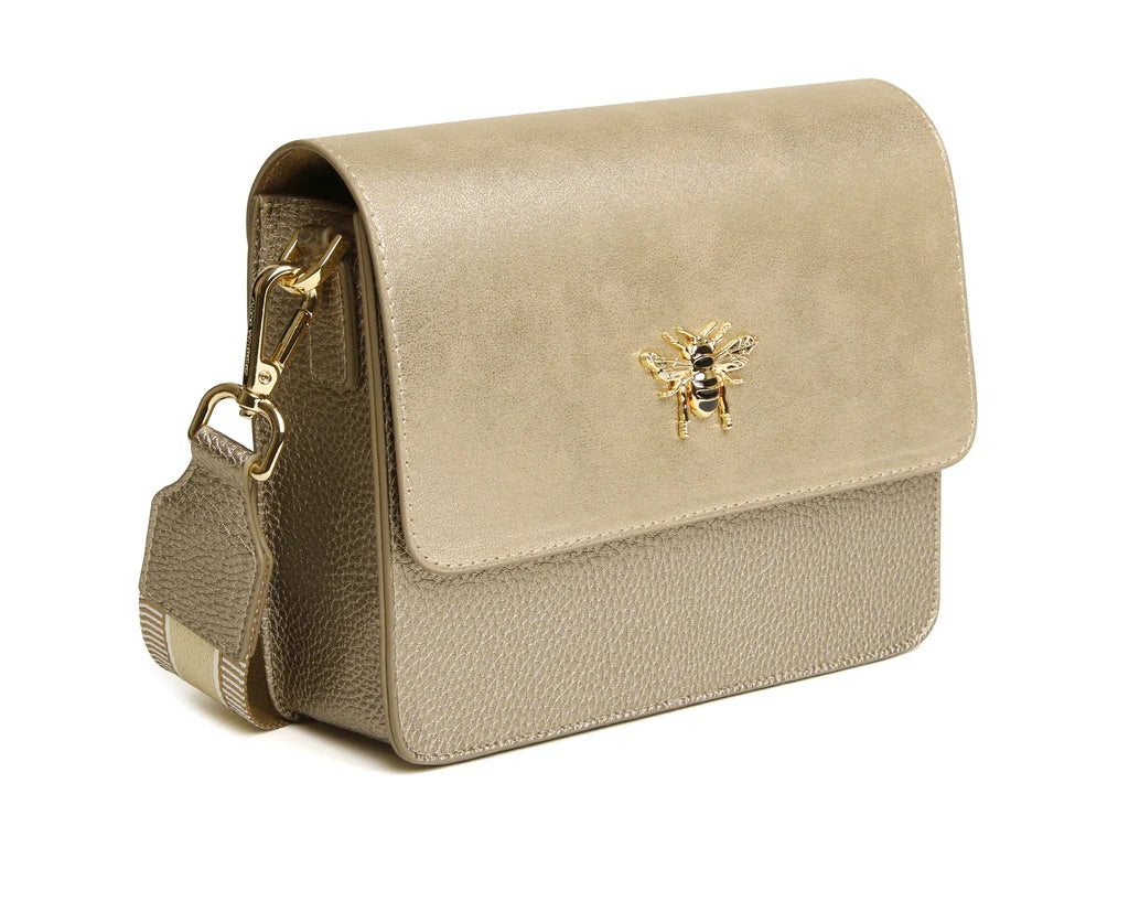 Beige handbag with a gold bee emblem on a white background