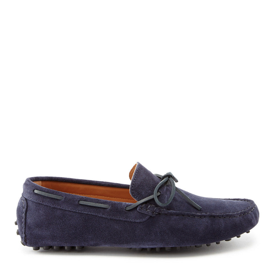 Navy blue suede loafer on a white background