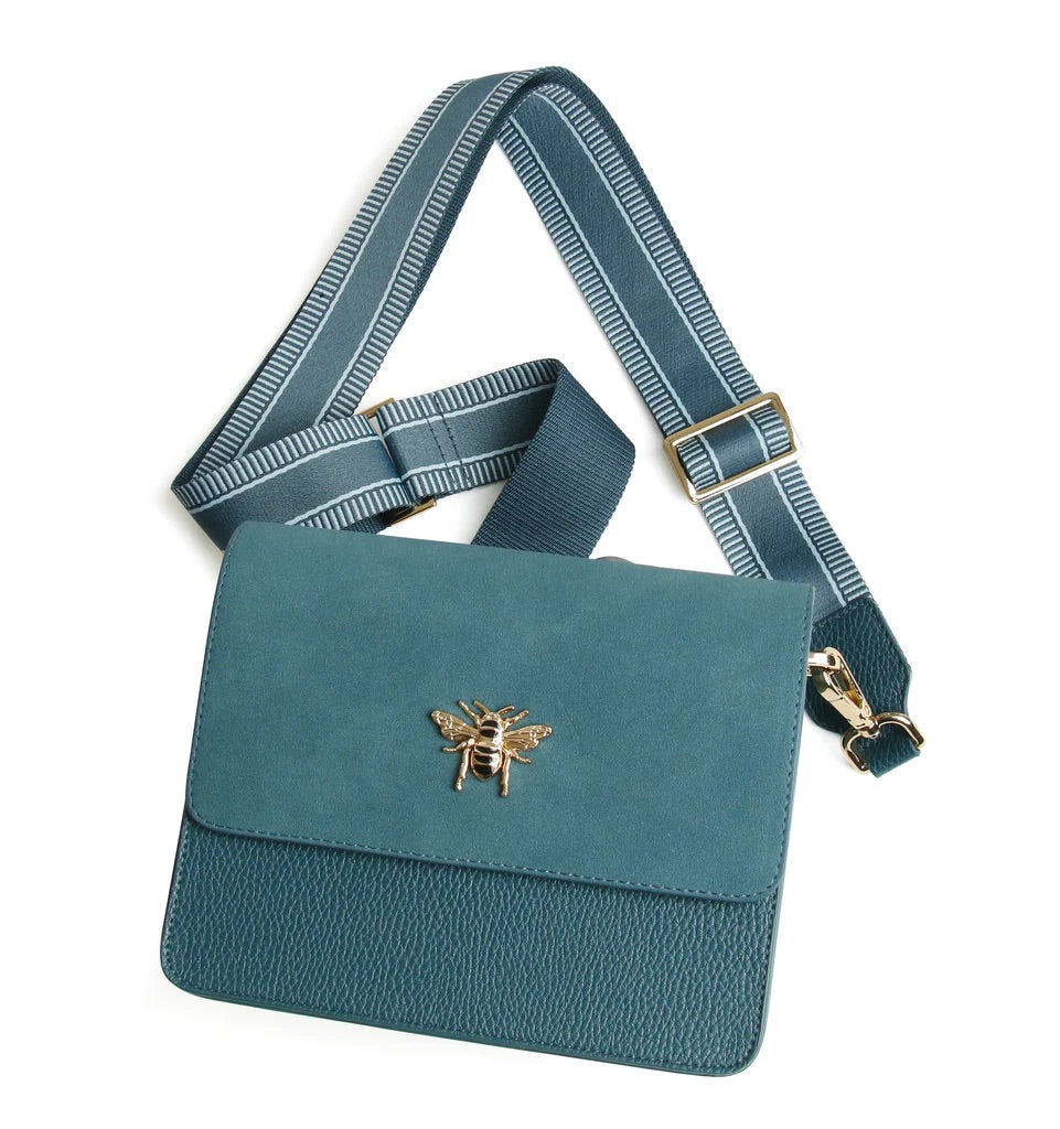 Teal handbag with a bee emblem and matching strap on a white background