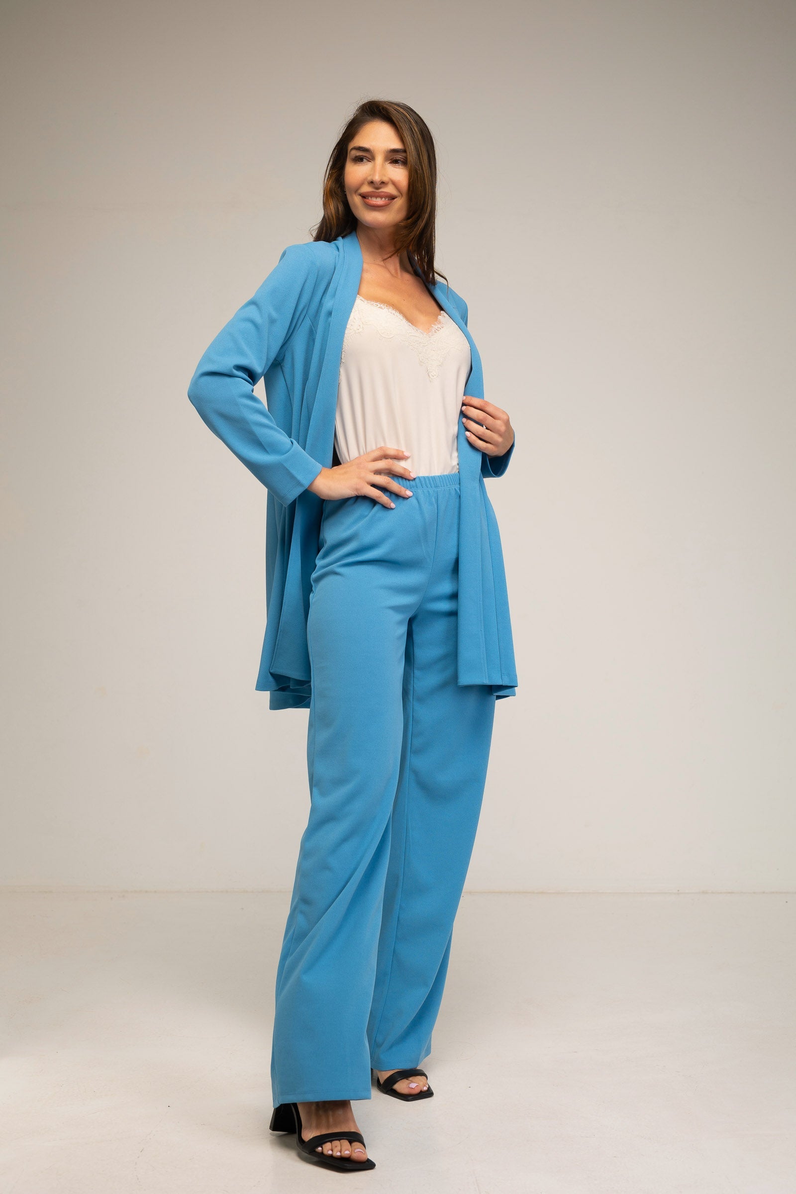 Woman wearing a blue outfit with a white background