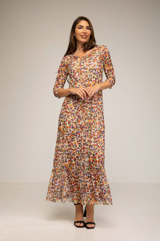 Woman wearing a floral dress against a plain background