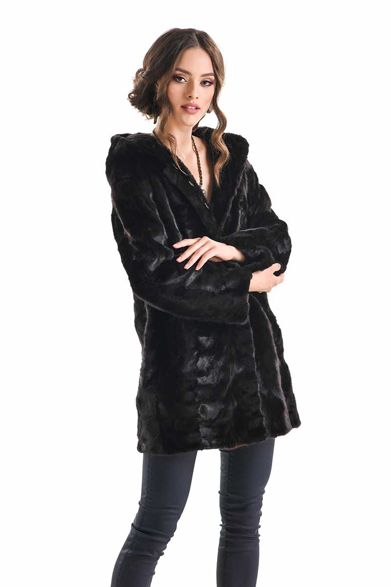 Woman wearing a brown fur coat on a white background