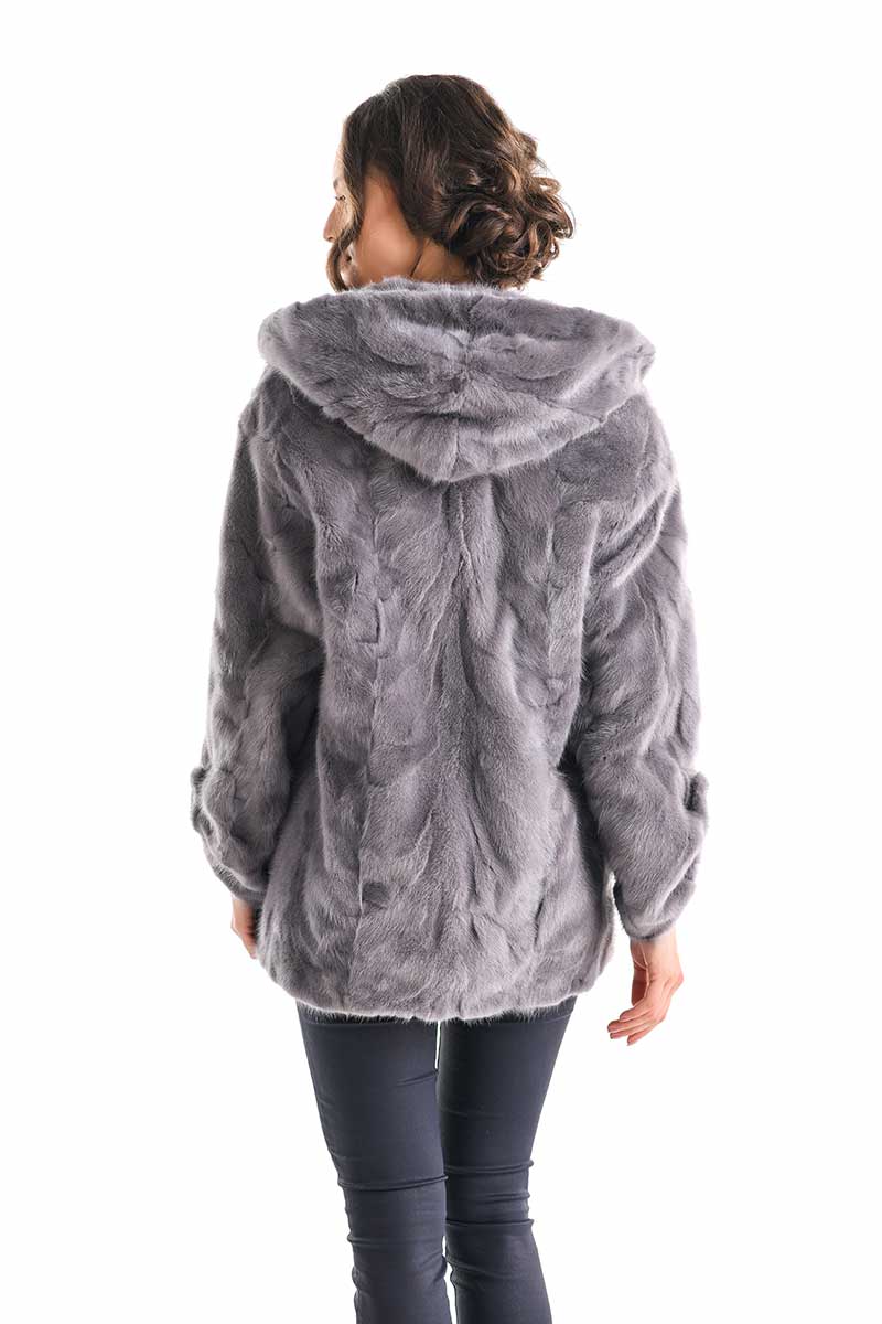 Person wearing a gray fur jacket on a white background