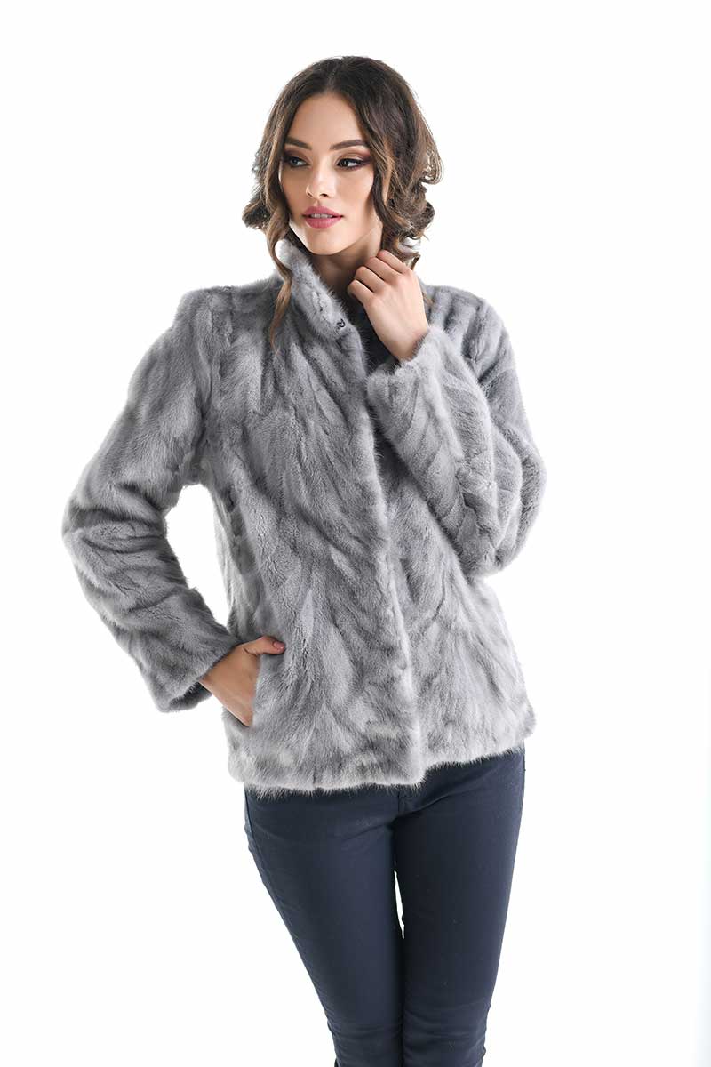 Woman wearing a gray fur coat on a white background
