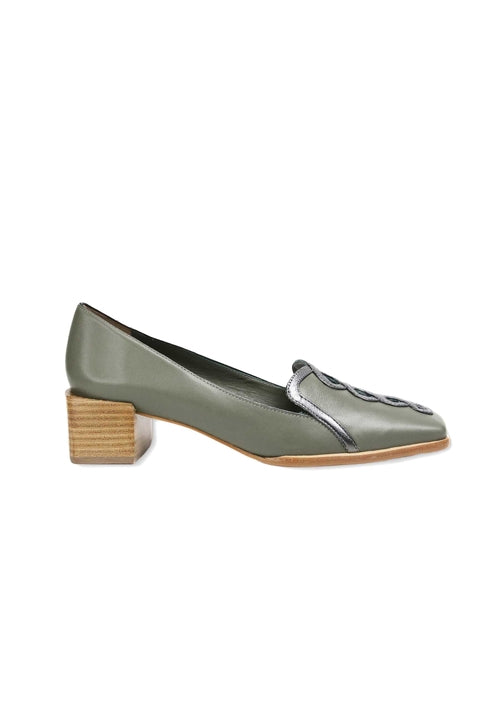 Green shoe with a wooden block heel on a white background