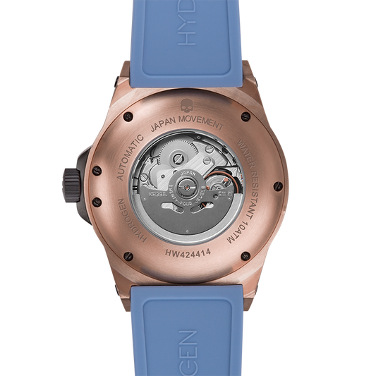 Watch with blue strap and rose gold case on a white background