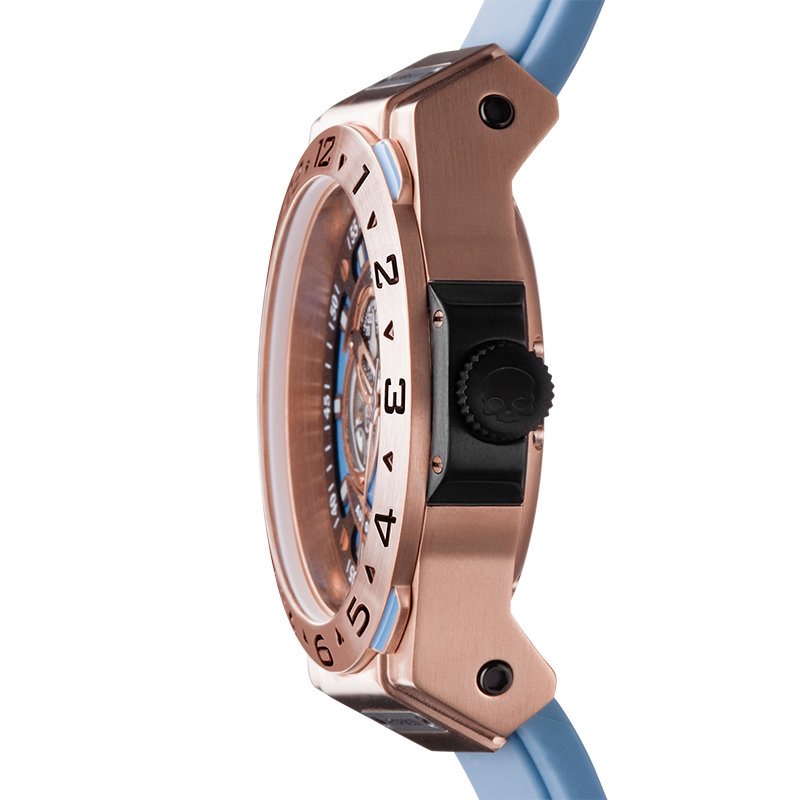 Close-up of a rose gold watch with a blue strap on a white background