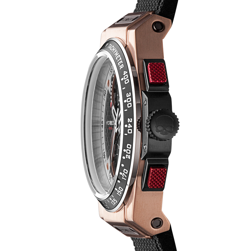 Close-up of a rose gold watch with a black strap and red accents on a white background