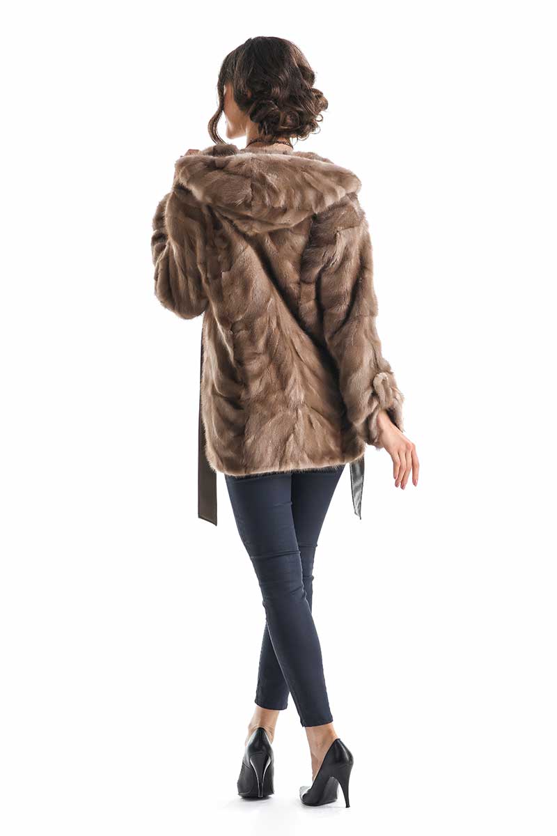 Woman wearing a brown faux fur coat on a white background