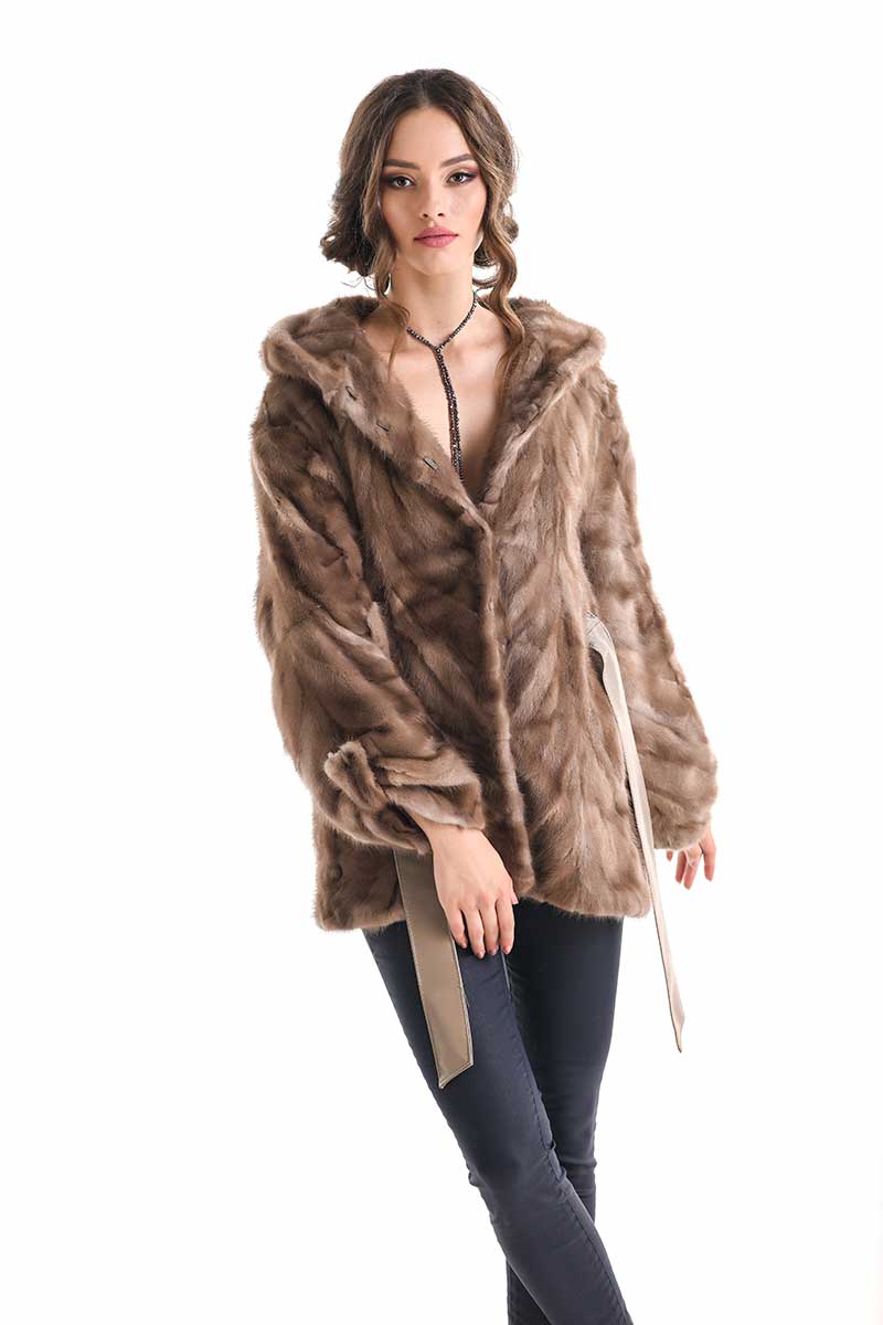 Woman wearing a brown fur coat on a white background