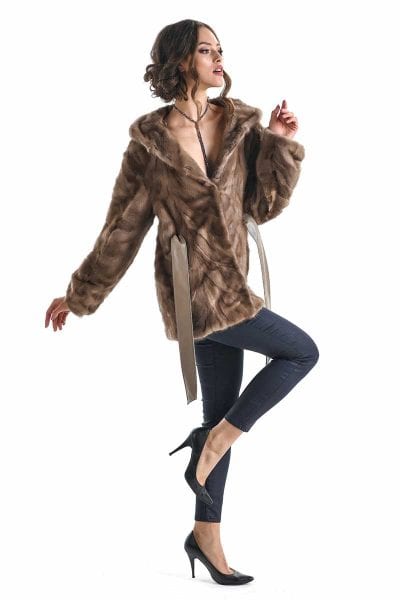 Woman wearing a brown fur coat on a white background