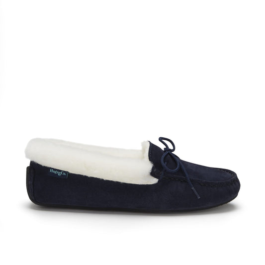 Navy blue moccasin slipper with white lining on a white background