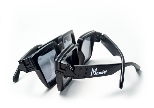 Black sunglasses with 'Monett' branding on a white background