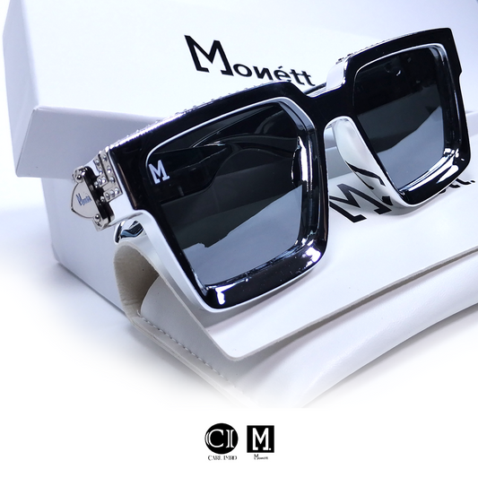 Black sunglasses with diamond accents on a white box, featuring the brand 'Monett'.