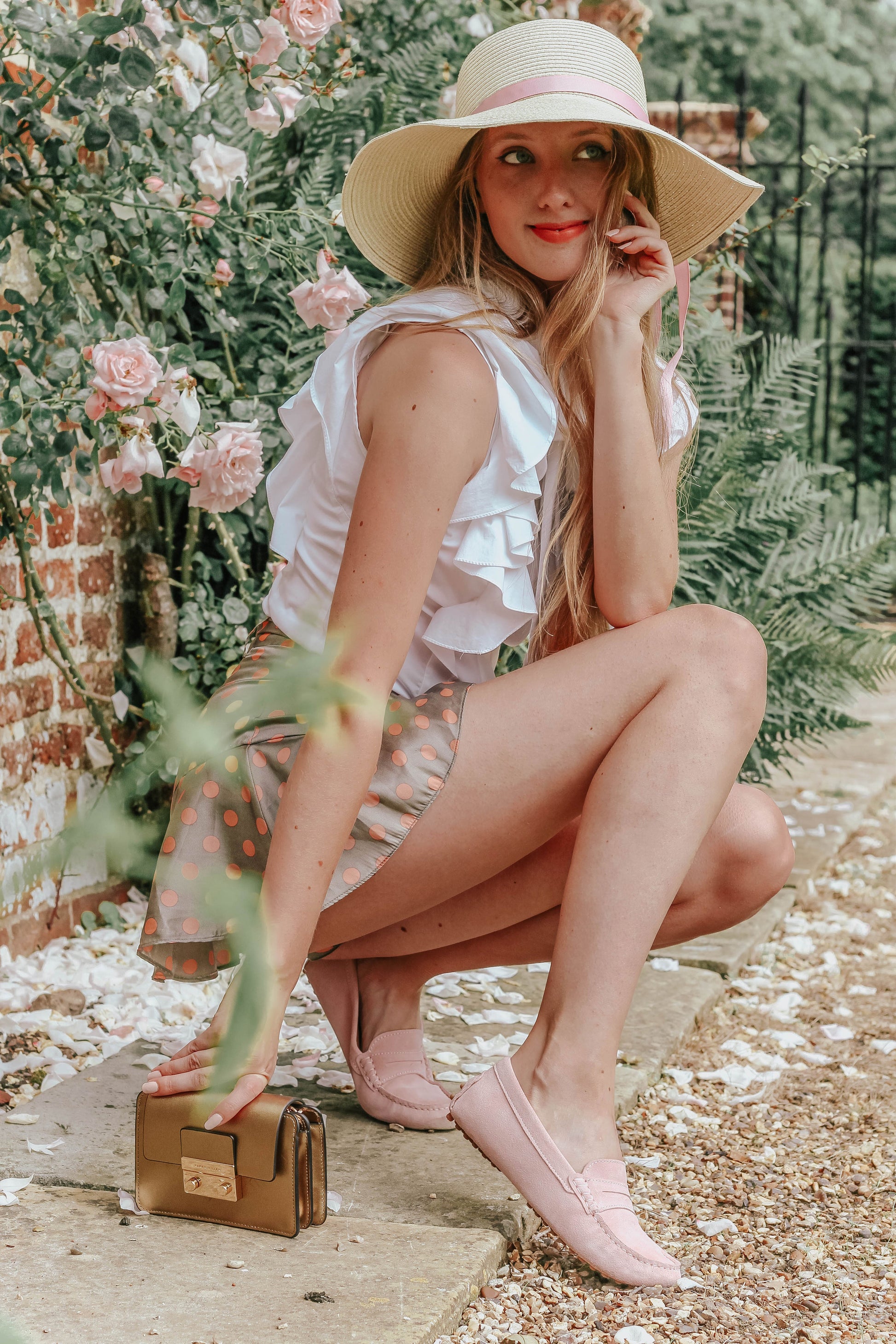 Woman wearing Pink loafers on garden background