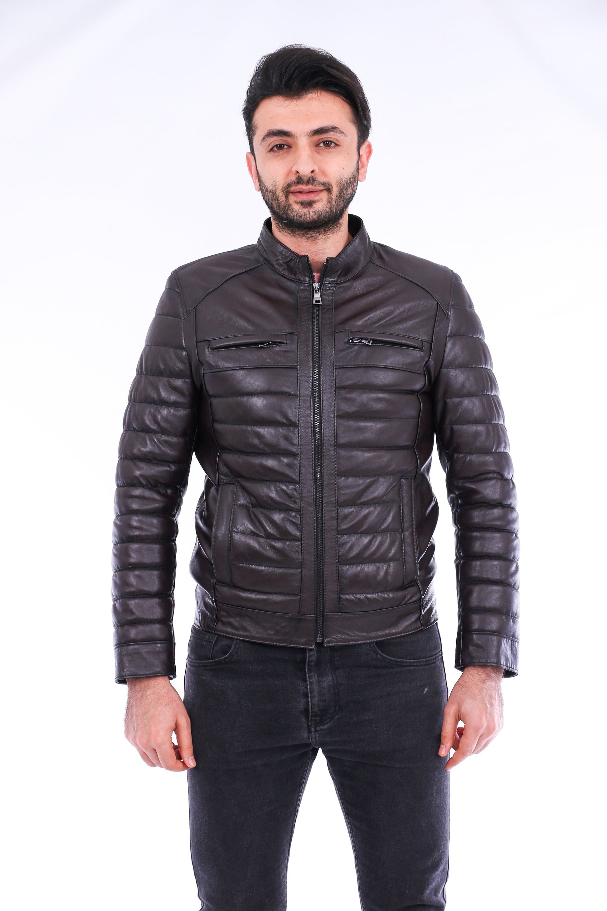 Man wearing a black quilted jacket on a white background