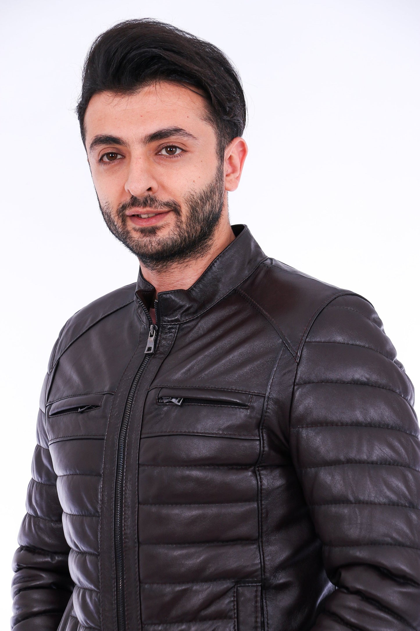 Man wearing a black puffer jacket against a white background