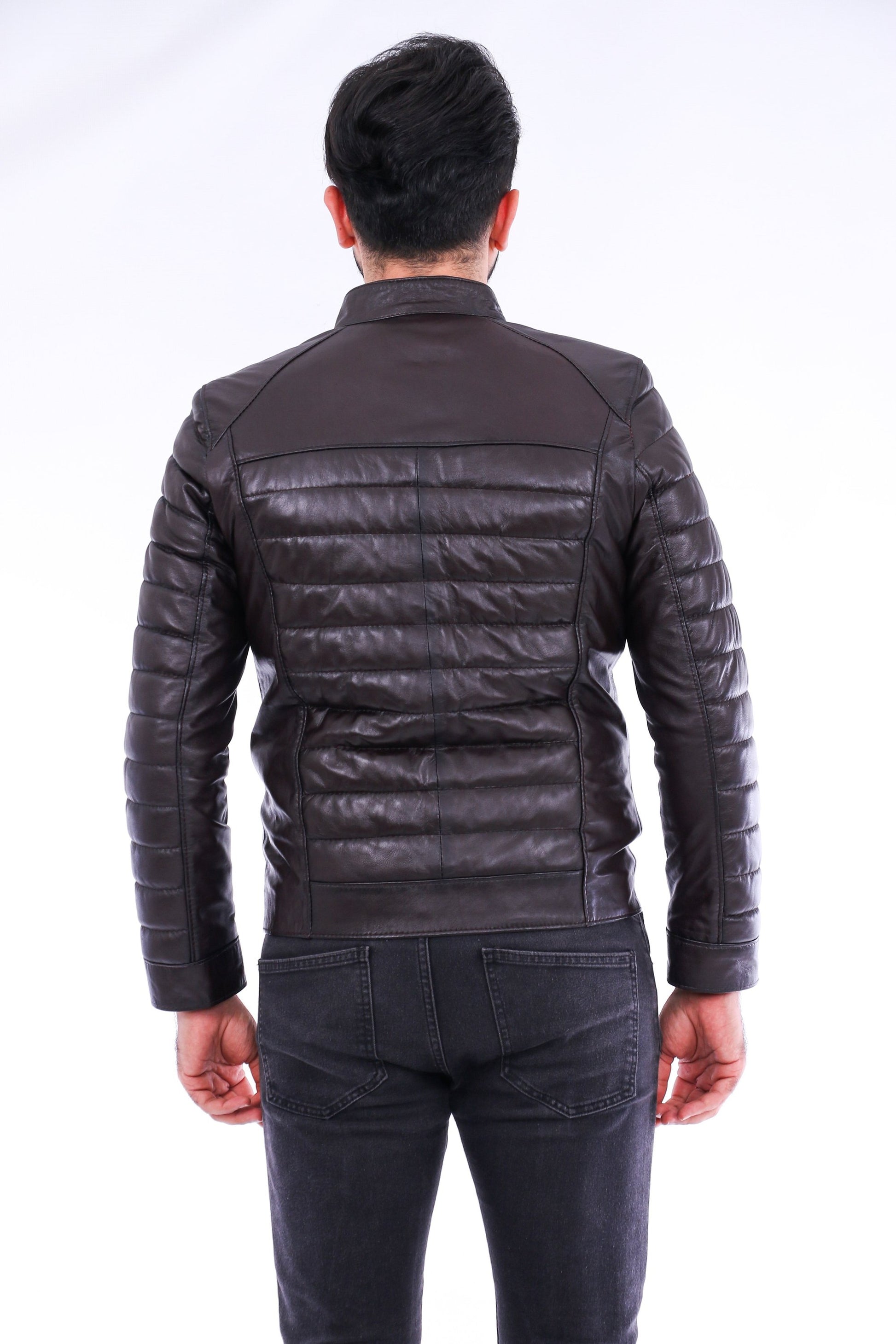 Person wearing a black leather jacket from behind on a white background