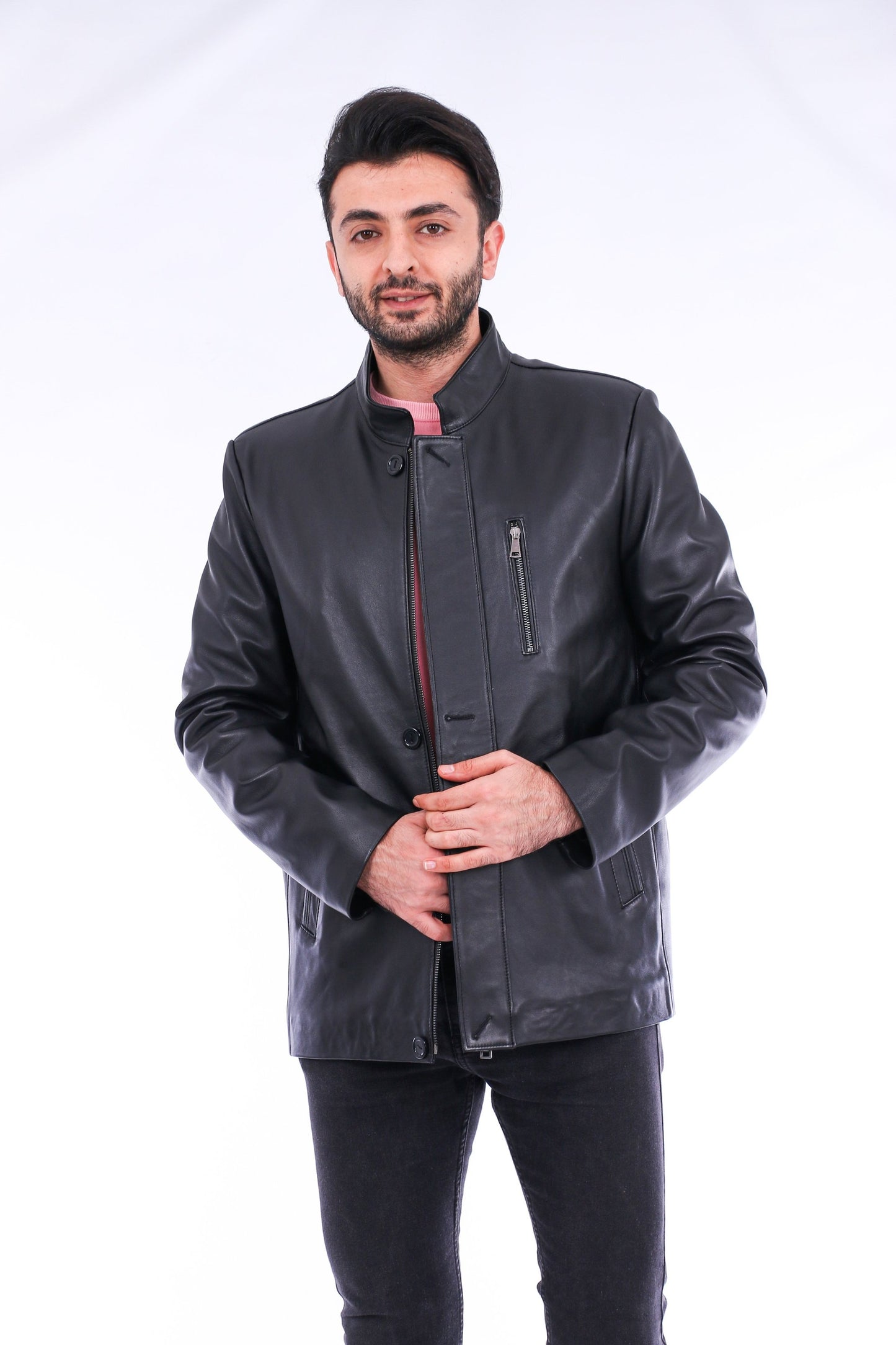 Man wearing a dark gray leather jacket on a white background