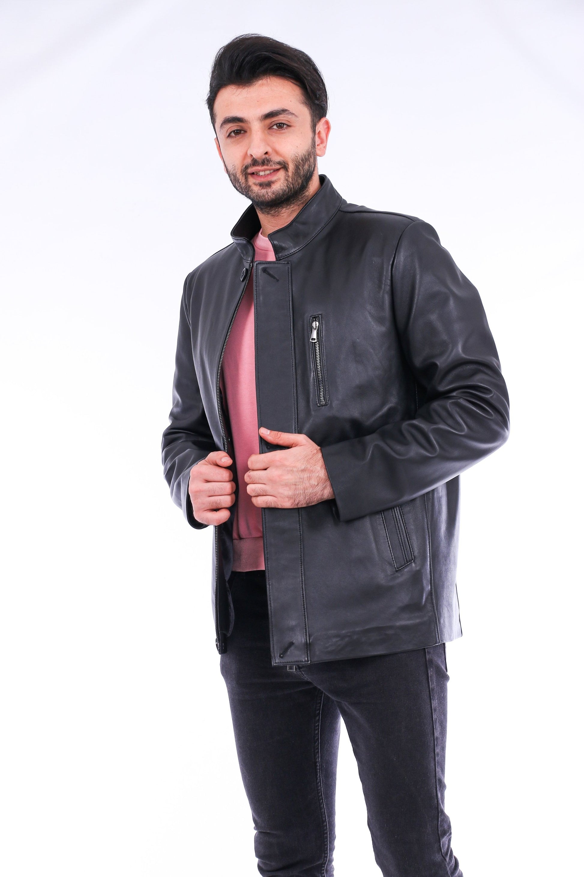 Man wearing a dark gray leather jacket on a white background