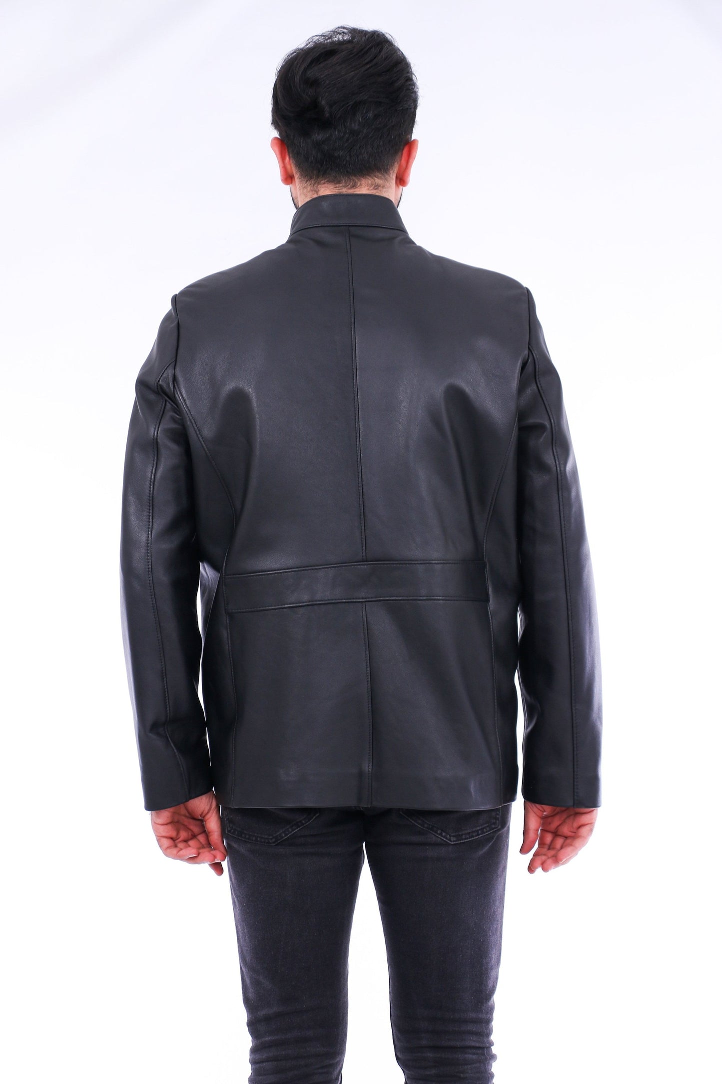 Person wearing a black leather jacket from behind on a white background