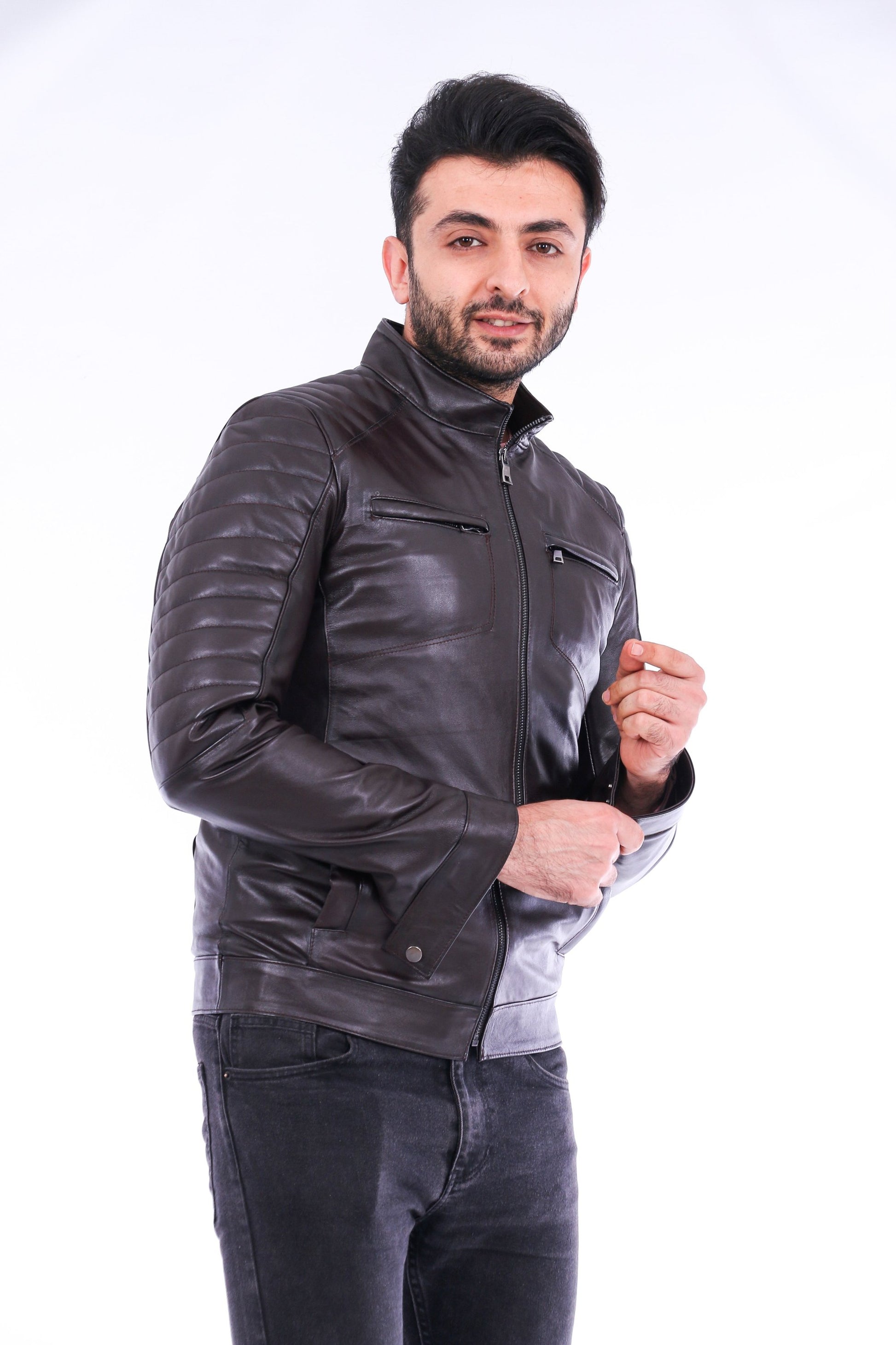 Man wearing a dark leather jacket on a white background