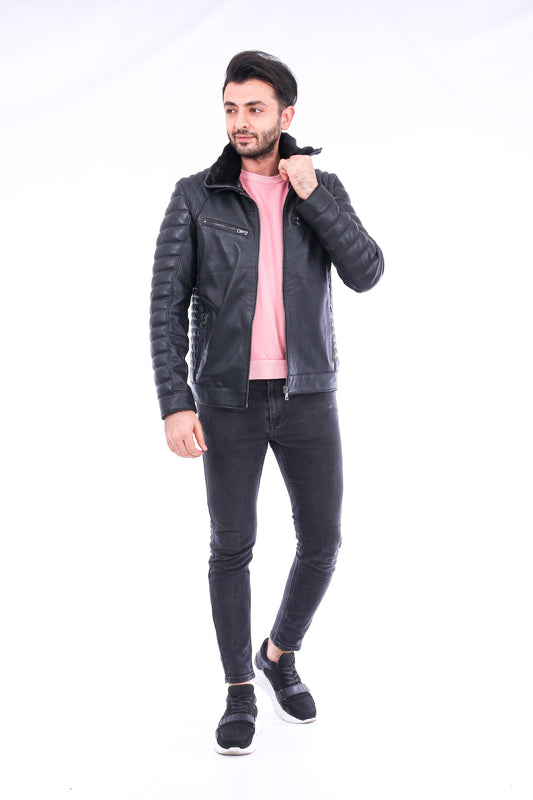 Man wearing a black leather jacket, pink shirt, and black jeans on a white background