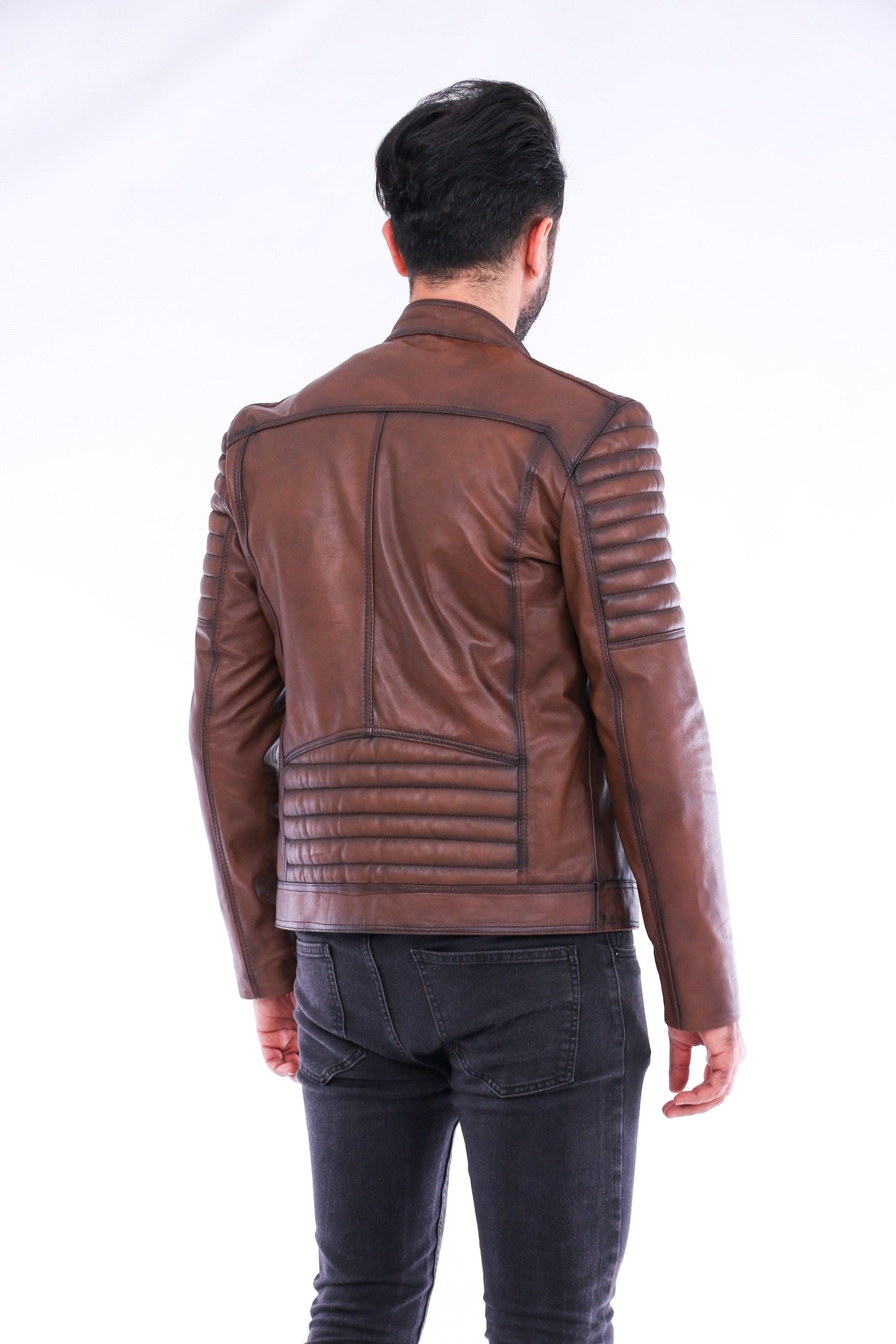 Person wearing a brown leather jacket on a white background