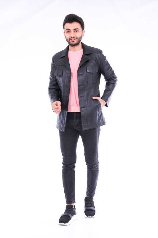 Man wearing a black jacket, pink shirt, and dark jeans on a white background