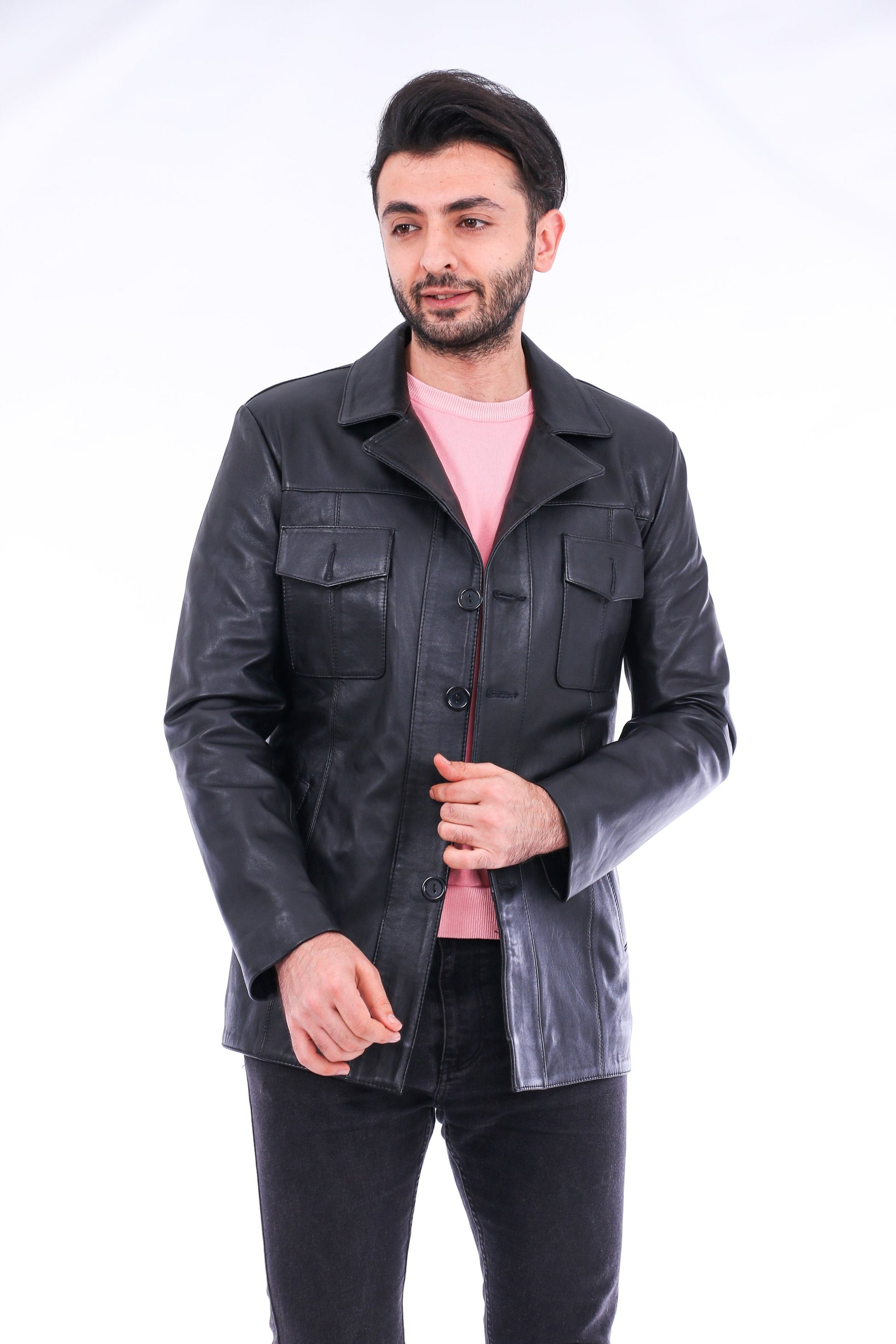 Man wearing a black leather jacket over a pink shirt on a white background