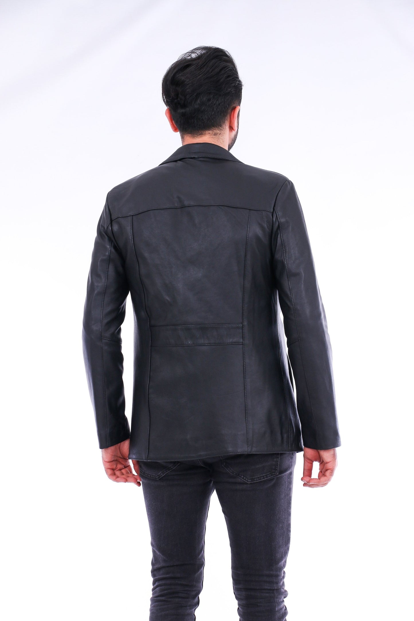 Person wearing a black leather jacket from behind on a white background