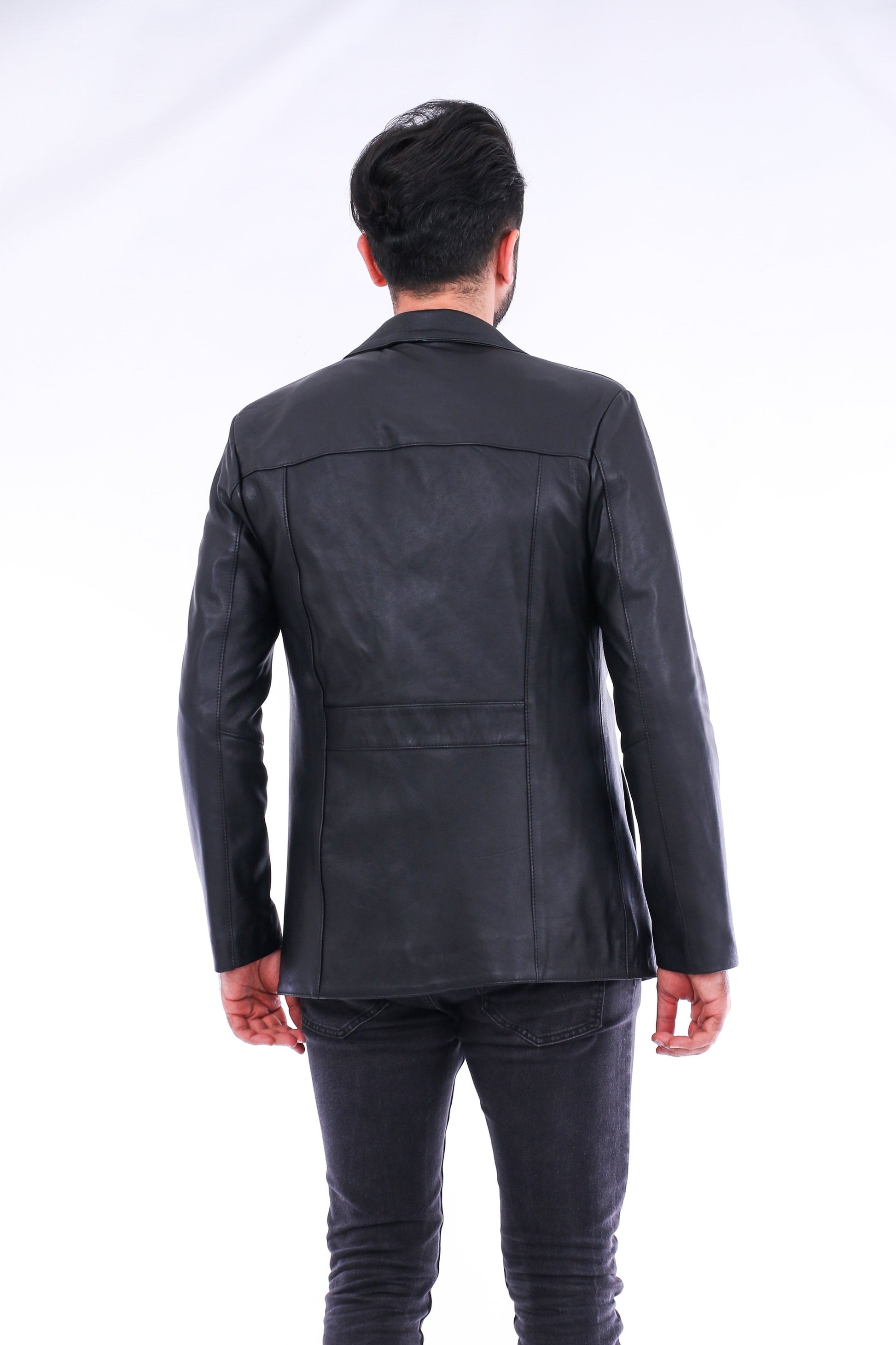 Person wearing a black leather jacket from behind on a white background