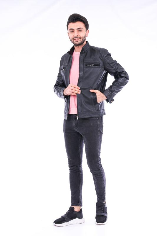 Man wearing a black leather jacket and jeans on a white background
