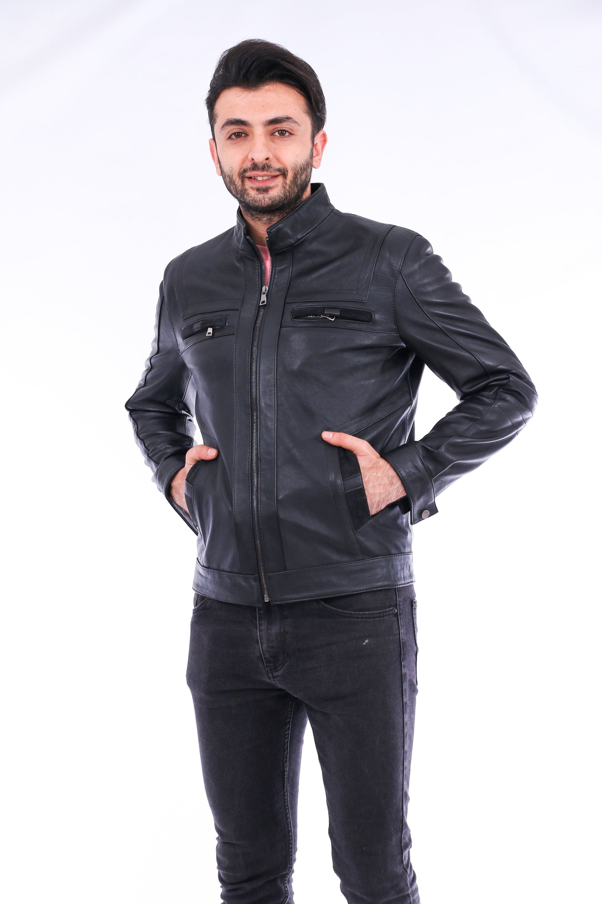 Man wearing a black leather jacket and jeans on a white background